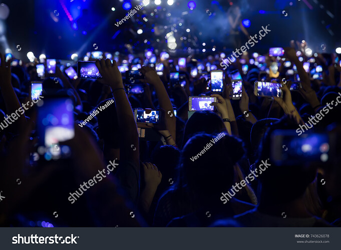 stock-photo-hand-with-a-smartphone-records-live-music-festival-taking-photo-of-concert-stage-live-concert-743626078